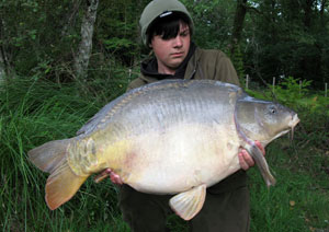 one of many portraits of happy fishermen with the carp they've just caught