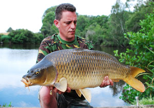 one of many portraits of happy fishermen with the carp they've just caught