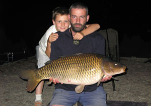 one of many portraits of happy fishermen with the carp they've just caught