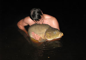 one of many portraits of happy fishermen with the carp they've just caught