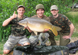 one of many portraits of happy fishermen with the carp they've just caught