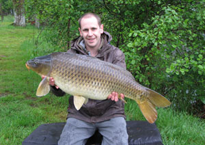 one of many portraits of happy fishermen with the carp they've just caught