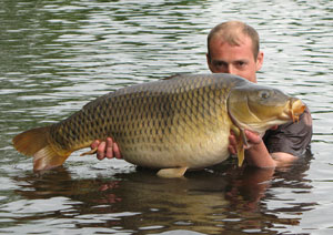 one of many portraits of happy fishermen with the carp they've just caught