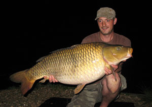 one of many portraits of happy fishermen with the carp they've just caught