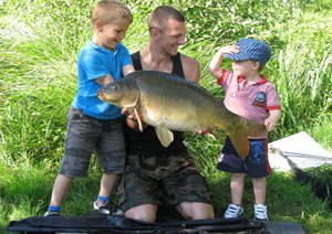 one of many portraits of happy fishermen with the carp they've just caught