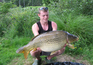 one of many portraits of happy fishermen with the carp they've just caught