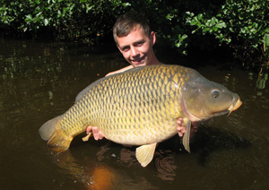 one of many portraits of happy fishermen with the carp they've just caught