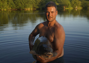 one of many portraits of happy fishermen with the carp they've just caught