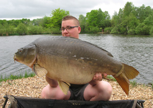 one of many portraits of happy fishermen with the carp they've just caught