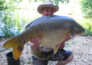 one of many portraits of happy fishermen with the carp they've just caught