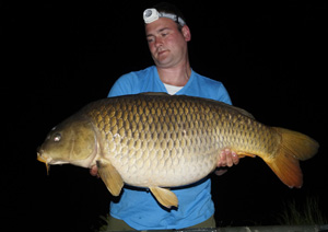 one of many portraits of happy fishermen with the carp they've just caught