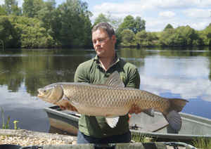 one of many portraits of happy fishermen with the carp they've just caught