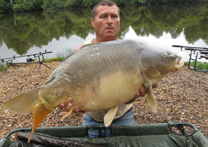 one of many portraits of happy fishermen with the carp they've just caught