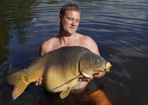 one of many portraits of happy fishermen with the carp they've just caught